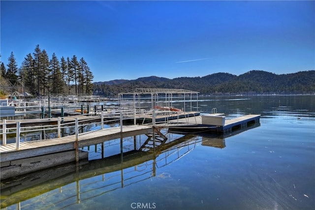 view of dock with a water and mountain view