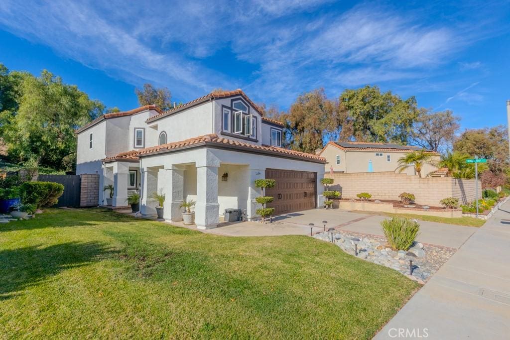 view of front of house with a front lawn and a garage