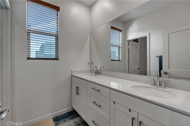 bathroom with tile patterned floors and vanity