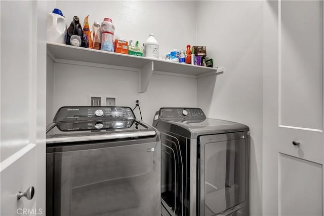 clothes washing area featuring independent washer and dryer