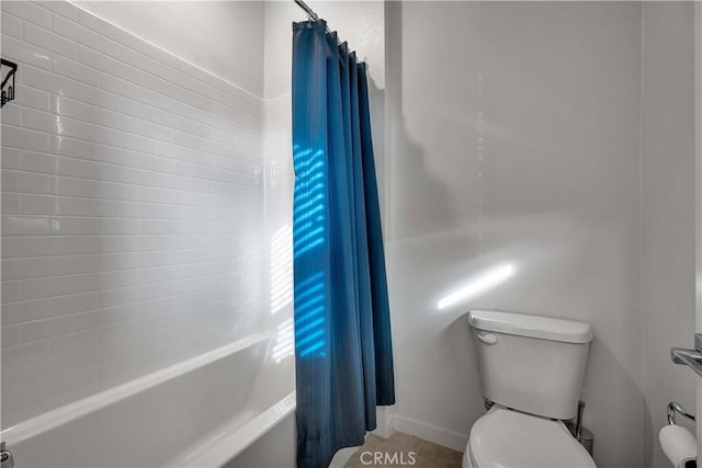 bathroom with toilet and shower / bath combo with shower curtain