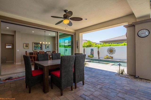 dining room featuring ceiling fan with notable chandelier