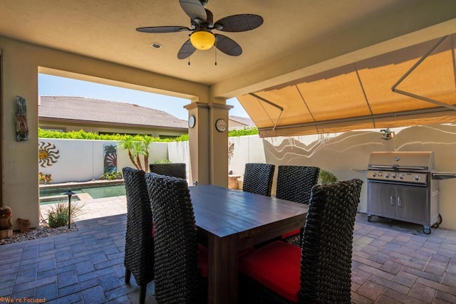 view of patio / terrace with a fenced in pool and area for grilling