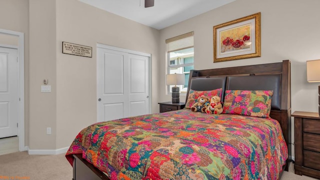 carpeted bedroom featuring ceiling fan and a closet