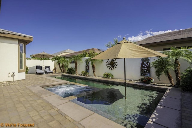 view of swimming pool with a hot tub