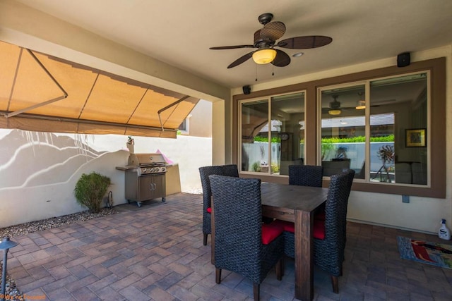 view of patio featuring area for grilling and ceiling fan