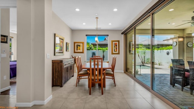 tiled dining room with ceiling fan and plenty of natural light