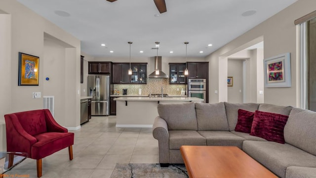 living room featuring ceiling fan and light tile patterned floors