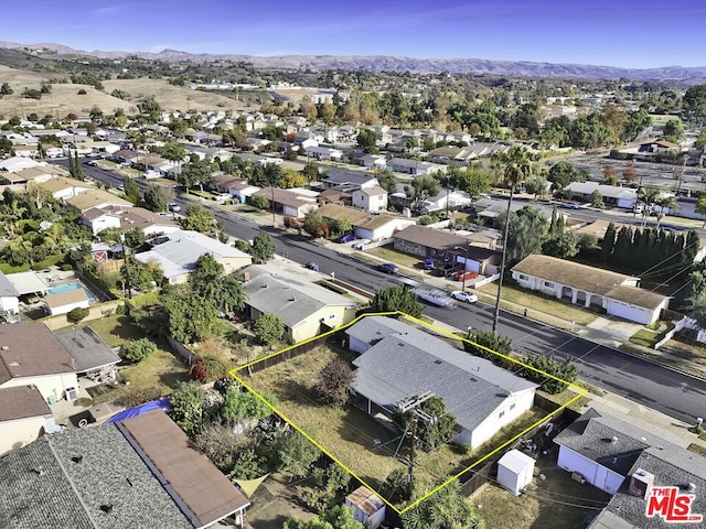 birds eye view of property featuring a mountain view