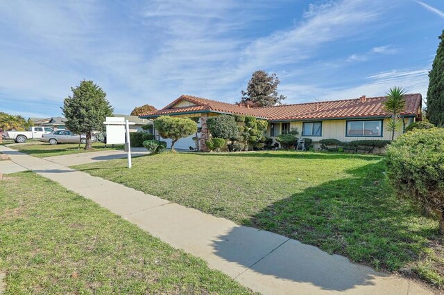 view of front of house with a garage and a front yard