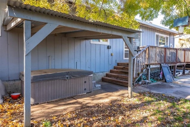 exterior space with a hot tub and a wooden deck