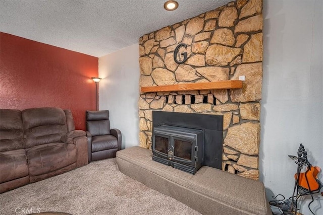 living room with carpet, a wood stove, and a textured ceiling