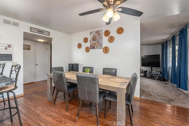 dining room with hardwood / wood-style flooring and ceiling fan