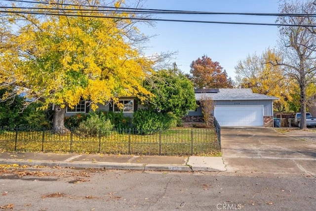 obstructed view of property with a garage