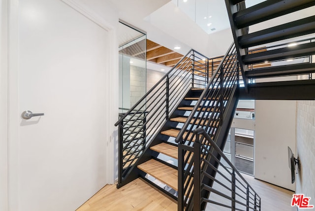 stairway featuring hardwood / wood-style flooring