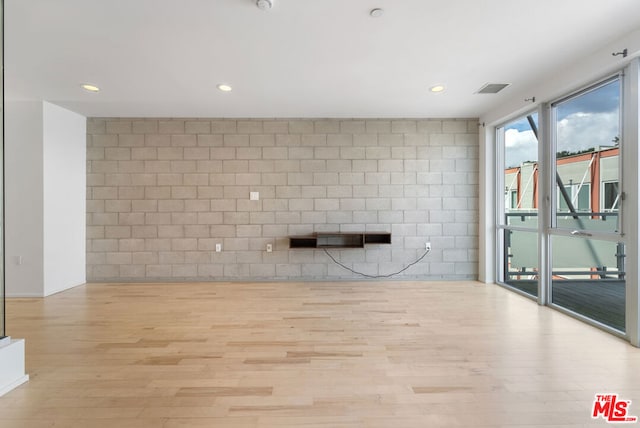 workout area with light hardwood / wood-style floors