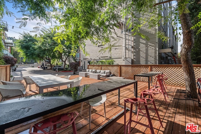 wooden terrace featuring an outdoor living space