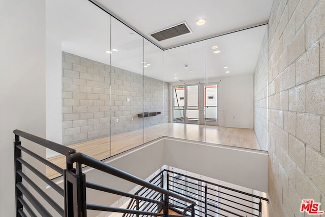 staircase with hardwood / wood-style flooring