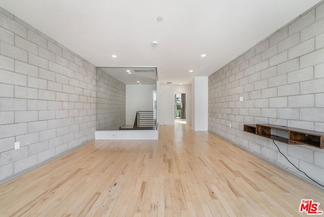 unfurnished living room featuring a fireplace and light hardwood / wood-style flooring