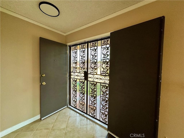 interior space featuring light tile patterned flooring, crown molding, and a textured ceiling