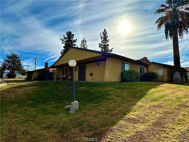 view of property exterior with a lawn