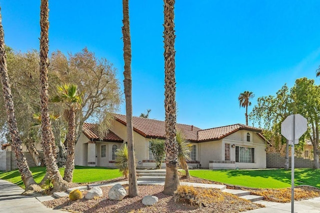 mediterranean / spanish-style home featuring a front yard