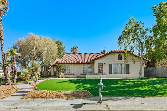 mediterranean / spanish-style home with a front yard