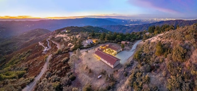 aerial view at dusk featuring a mountain view