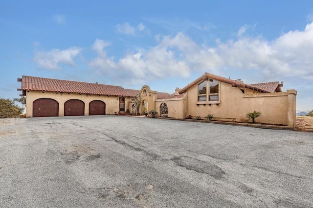 mediterranean / spanish house with a garage