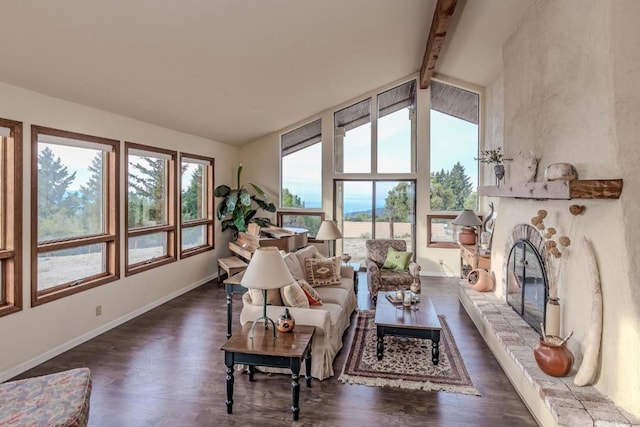 interior space with plenty of natural light, lofted ceiling with beams, and dark hardwood / wood-style flooring