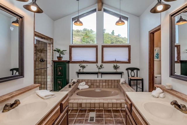 bathroom featuring vanity, independent shower and bath, and lofted ceiling