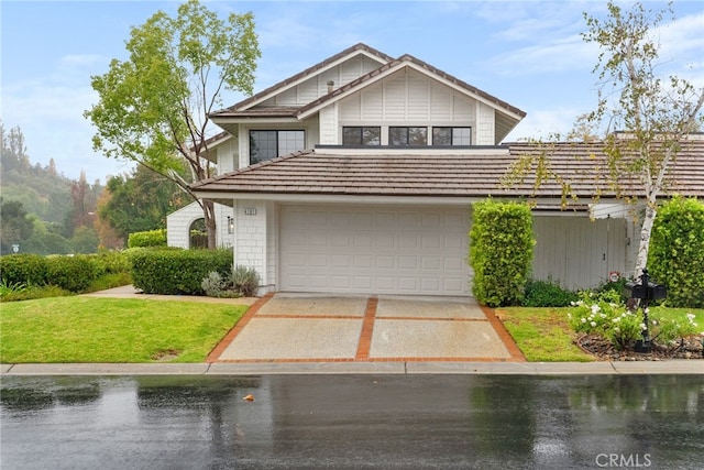 front facade with a garage and a front lawn