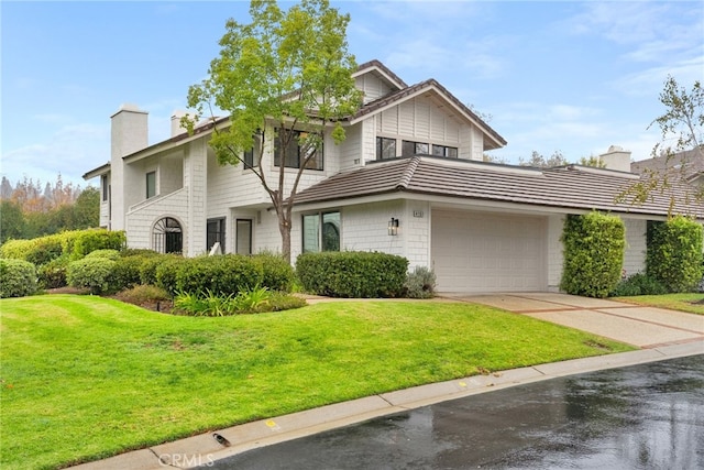 view of front of property with a garage and a front yard