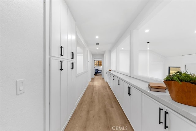 hallway with light hardwood / wood-style flooring