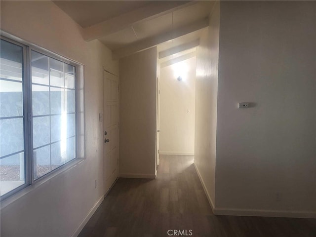 hallway featuring lofted ceiling with beams and dark wood-type flooring