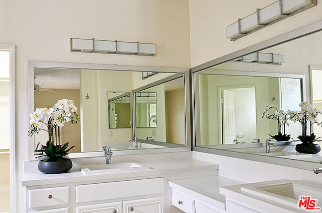 bathroom featuring ceiling fan, vanity, and a healthy amount of sunlight