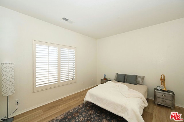 bedroom featuring wood-type flooring