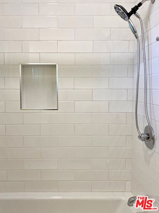 bathroom with tiled shower / bath combo