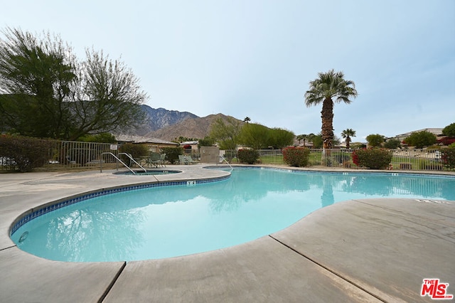 view of pool with a mountain view and a patio