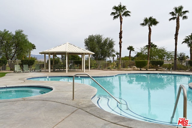 view of swimming pool featuring a gazebo, a community hot tub, and a patio