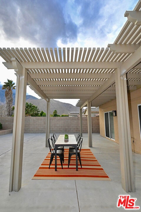 view of patio / terrace featuring a mountain view and a pergola