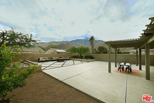 view of patio featuring a mountain view and a pergola