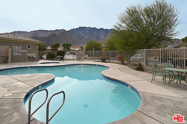 view of swimming pool featuring a mountain view and a patio area