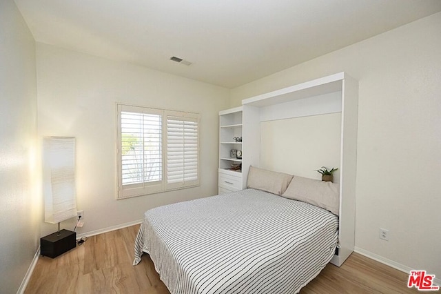 bedroom with light hardwood / wood-style flooring