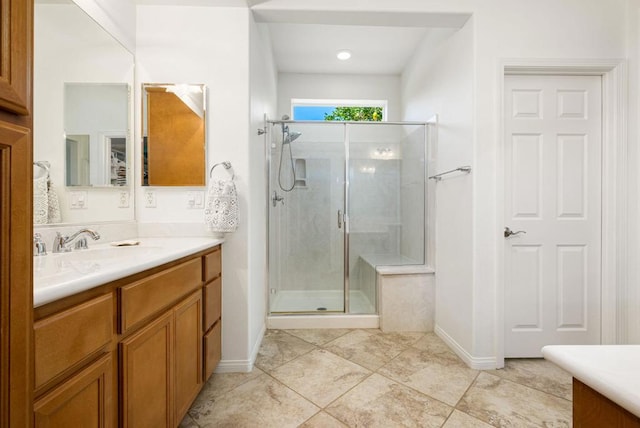 bathroom featuring an enclosed shower and vanity