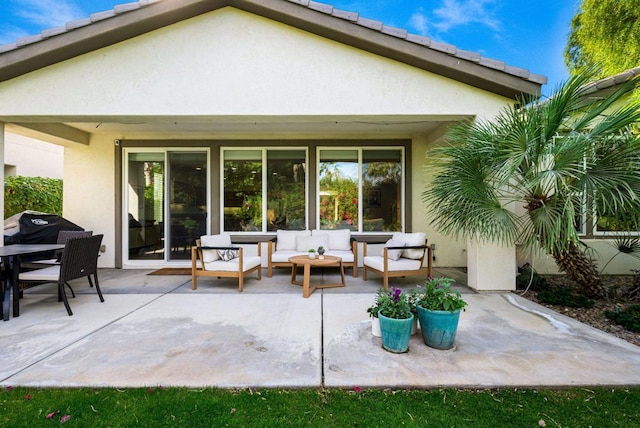 back of property featuring outdoor lounge area and a patio