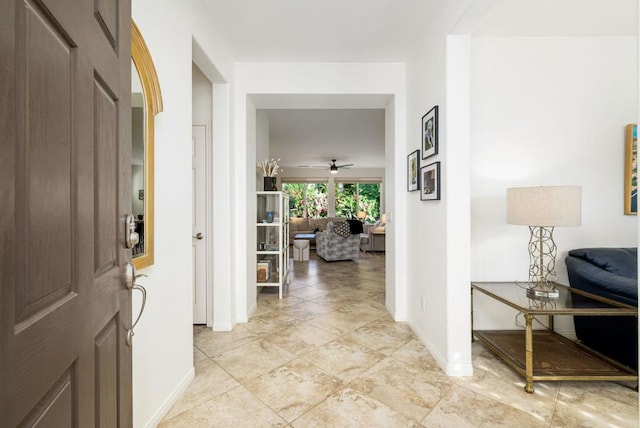 entrance foyer with ceiling fan