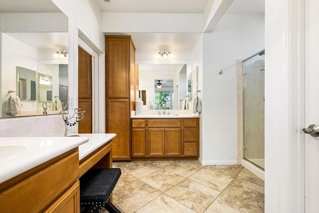 bathroom with a shower with shower door, vanity, and ceiling fan