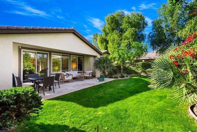 back of house with a yard, an outdoor living space, and a patio