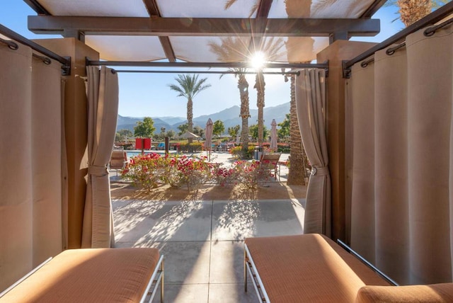 doorway to outside featuring tile patterned flooring and a mountain view